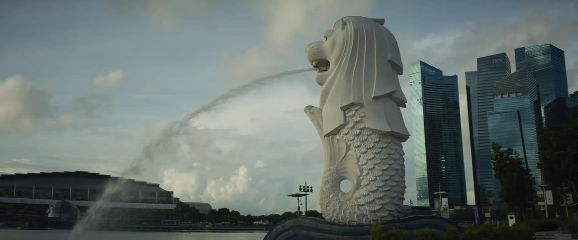 Singapore's iconic Merlion fountain spouts water across the bay in front of the city's modern skyscrapers