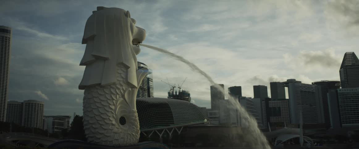 A steady shot of the iconic Merlion water fountain against the backdrop of the Singapore cityscape