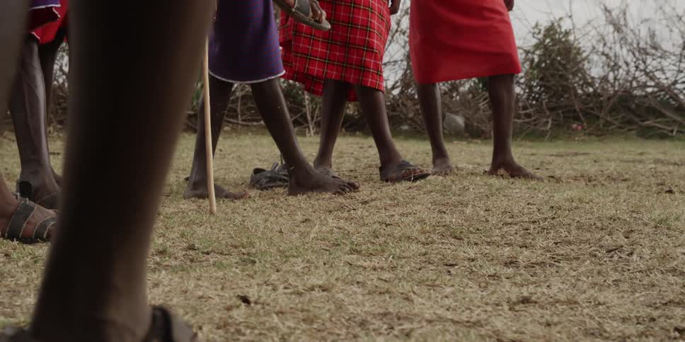 Group of people standing around a person jumping