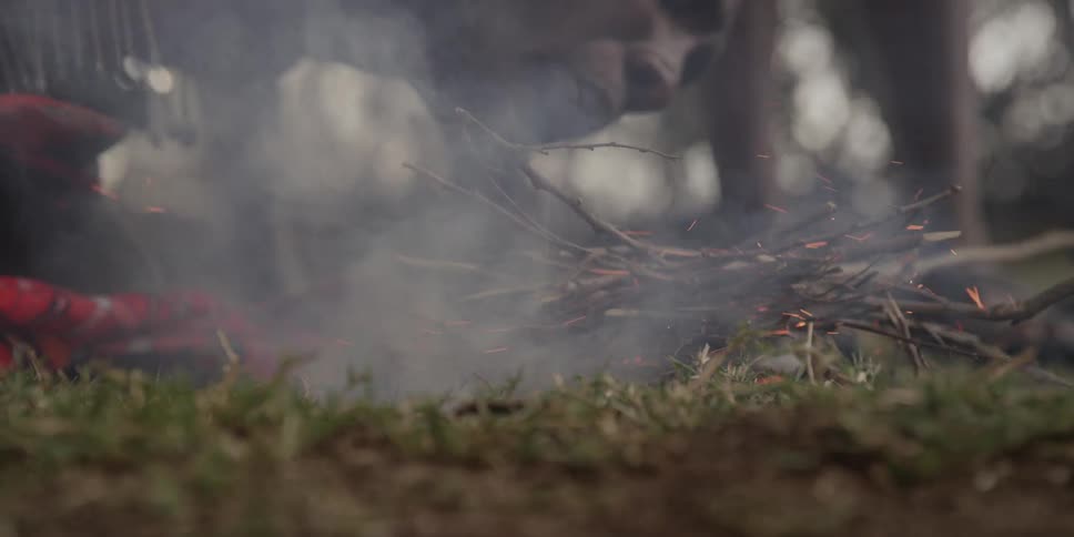 Bunch of branches smoking as someone blows on them
