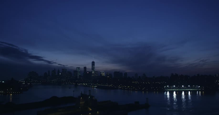 City skyline and skyscrapers next to the river at dusk