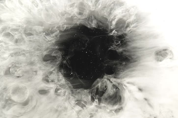 Ethereal white smoke slowly swirls around a dark, star-filled cosmic void