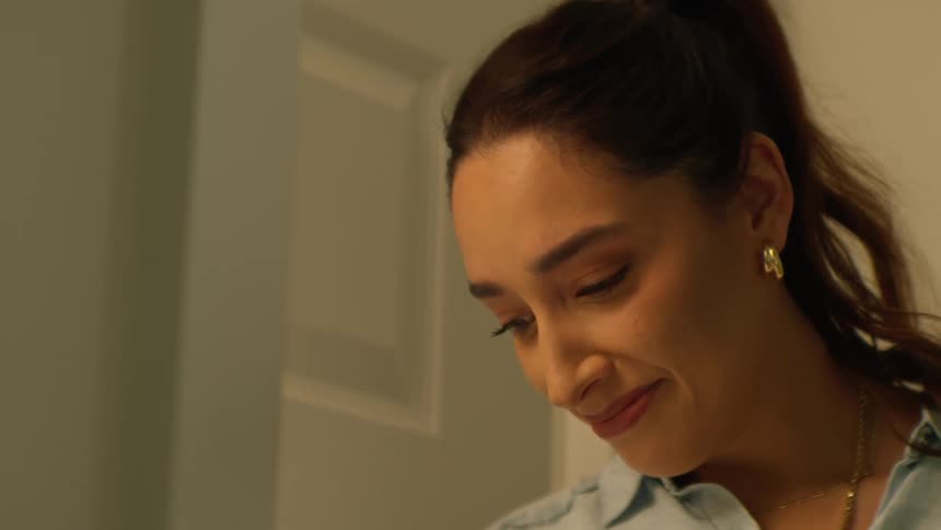 A woman's expression shifts from melancholic to joyful, then abruptly to fear as she looks off-screen