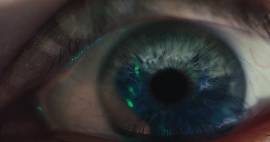 A dramatic and futuristic macro shot of a human eye opening, with a vibrant blue iris and glowing light reflections