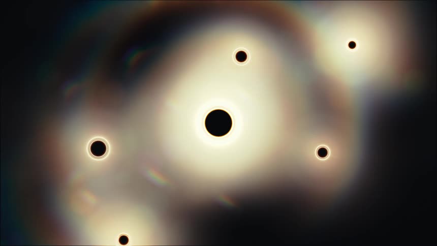An abstract animation shows glowing orbs resembling black holes or eclipses floating in a dark, atmospheric space with subtle rainbow light flares