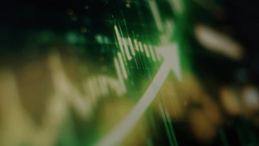 A digital display shows a stock market chart with a bullish upward trend in glowing green