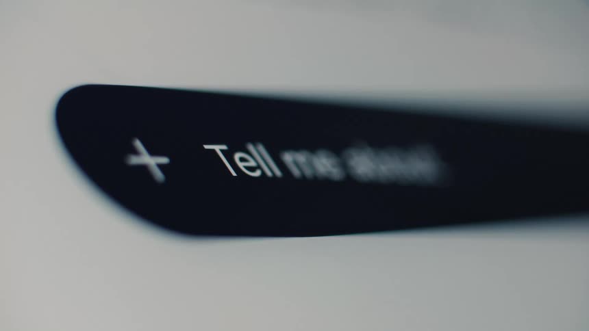 Close-up of a futuristic search bar on a screen where a user types a question to an AI