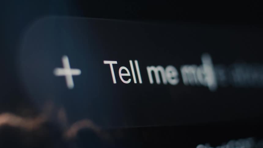 Extreme close-up of a user typing 'Tell me more' into a futuristic AI chat prompt on a digital screen