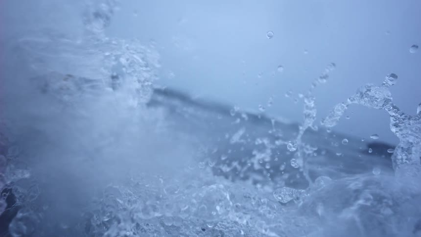 A mesmerizing macro shot captures the intricate details of splashing water in extreme slow motion