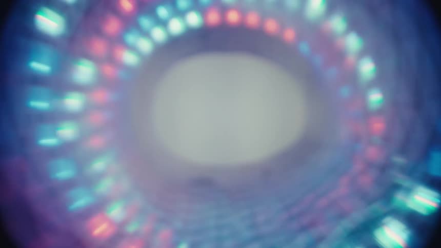 A hypnotic journey through a futuristic tunnel of swirling, multi-colored LED lights against a dark background