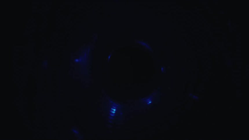An abstract, mesmerizing journey through a spiraling tunnel illuminated by changing colorful LED lights