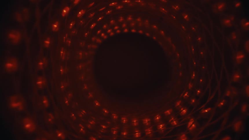 A slow, hypnotic journey through a swirling vortex of abstract red lights that pulse and fade into darkness