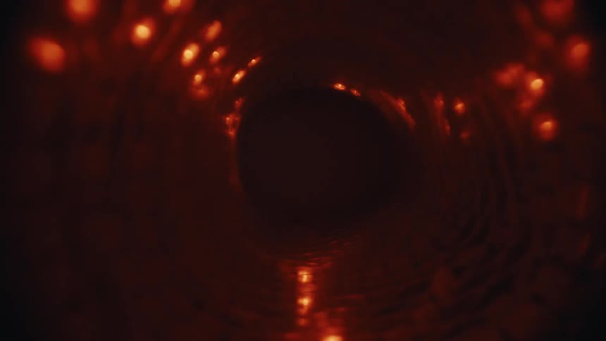 A POV shot moves through a dark, abstract tunnel with glowing red lights along the walls