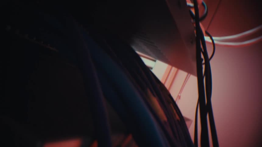 Close up cinematic shot revealing the back of a network server rack with ethernet cables plugged into the patch panel