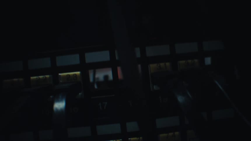 A close-up camera movement reveals a network switch with blinking lights in a dark server room as a cable is unplugged