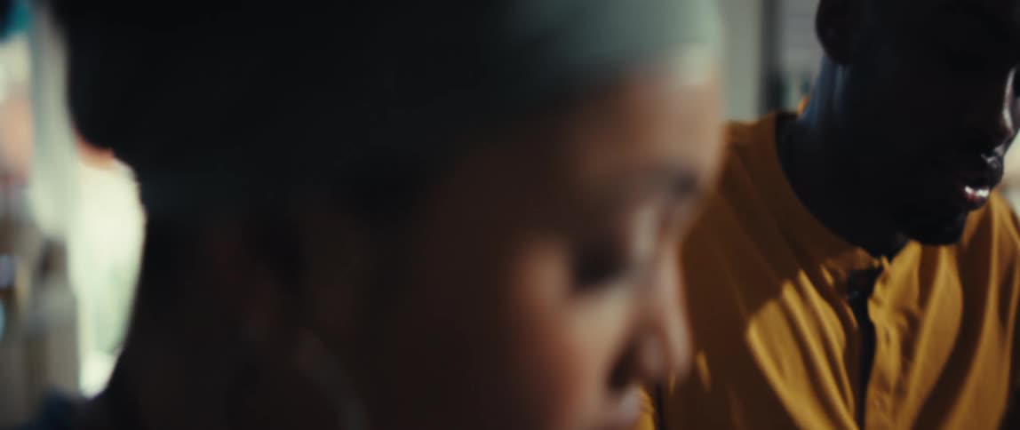 An intimate close-up shot rack focuses from a man talking to a woman listening with a serious expression