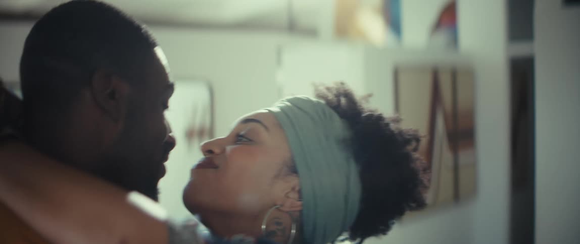 Young loving African American couple slow dancing together at home in slow motion