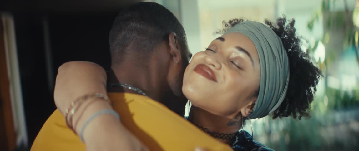 An affectionate African American couple slow dances in an intimate and loving embrace