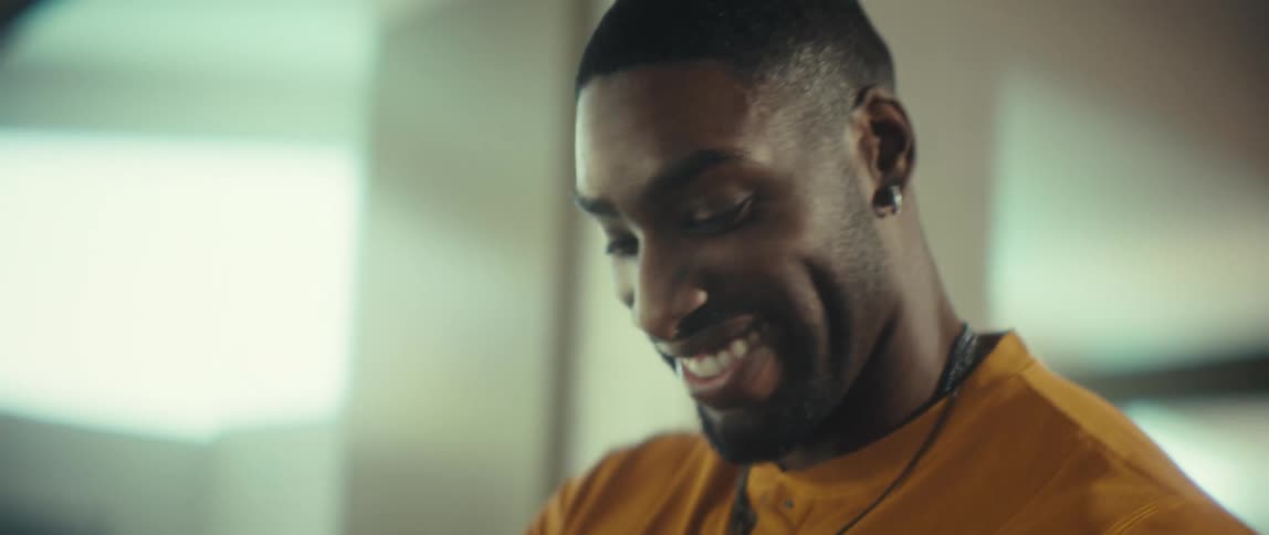 A stylish young couple shares a joyful, intimate dance in their sunlit apartment in slow motion