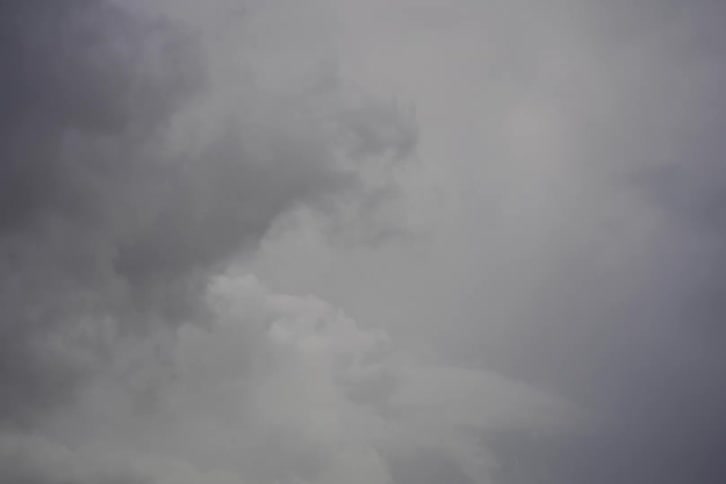 Ominous grey storm clouds slowly drift across the sky, forecasting bad weather