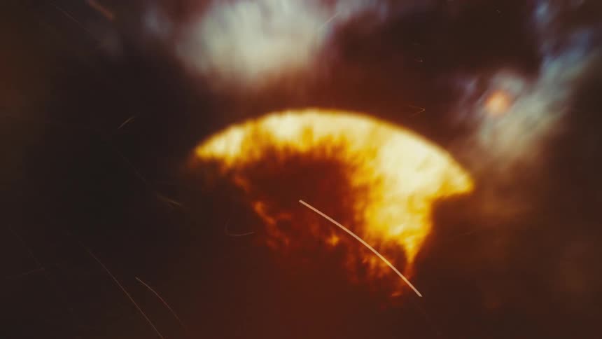 An intense and fiery close-up of a massive explosion stylized with a vintage film effect
