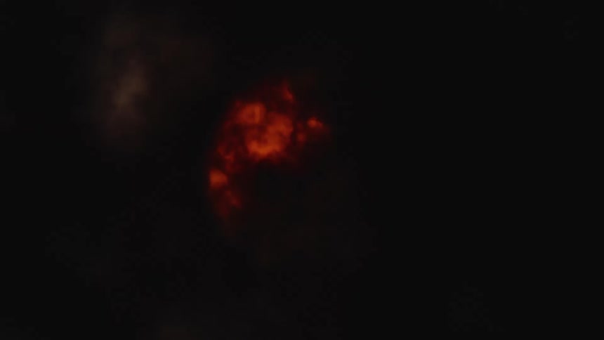 A mysterious, glowing orange celestial body moves behind dark, ominous clouds in a dramatic time-lapse