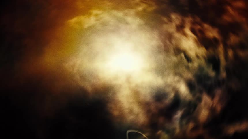 A journey through a swirling, colorful cosmic nebula with a bright central light source and glowing particle trails