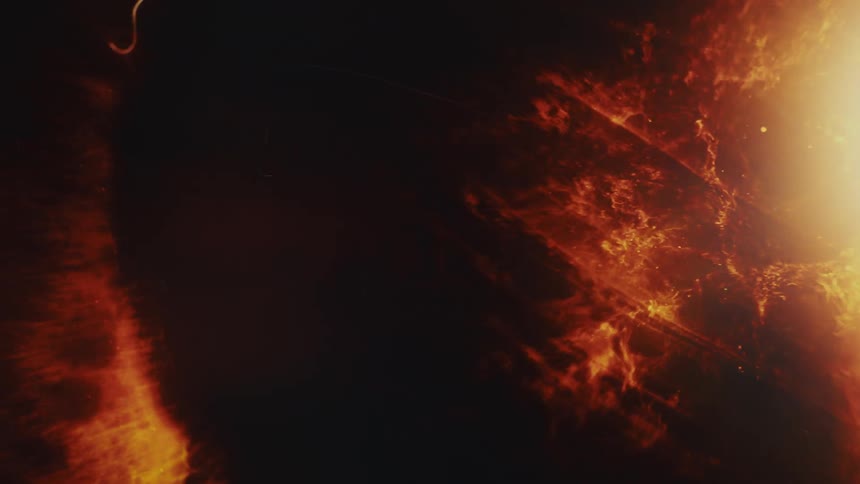 An intense and abstract background of fire, smoke, and light with glowing particles and streaks