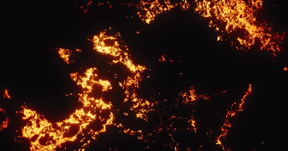 Aerial top-down view of a glowing red hot lava field solidifying at night
