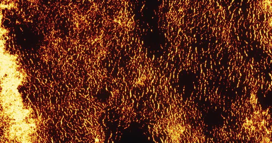 Molten gold texture with glowing embers slowly expands over a dark background