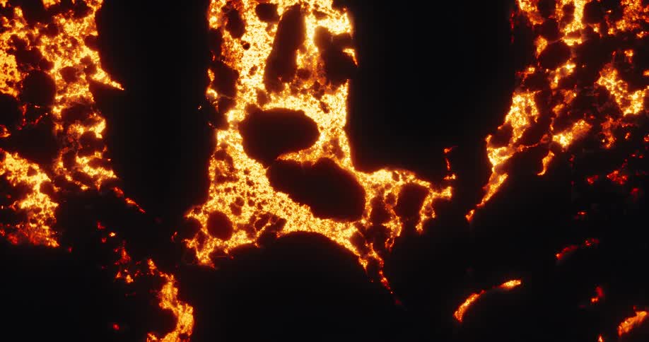Mesmerizing top-down shot of hot magma flowing and forming a crust of volcanic rock