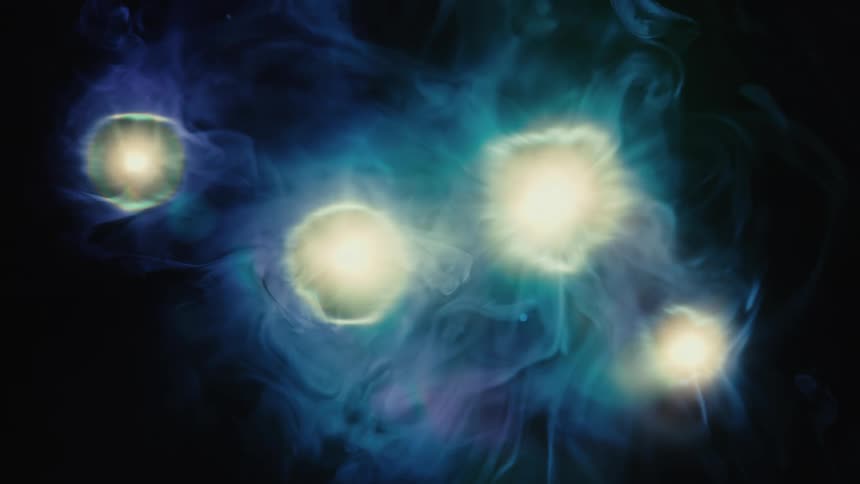 Four glowing celestial orbs pulse gently within a mystical and colorful blue and teal nebula in deep space