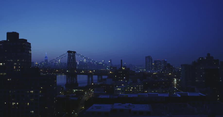 View of lit city at sunset