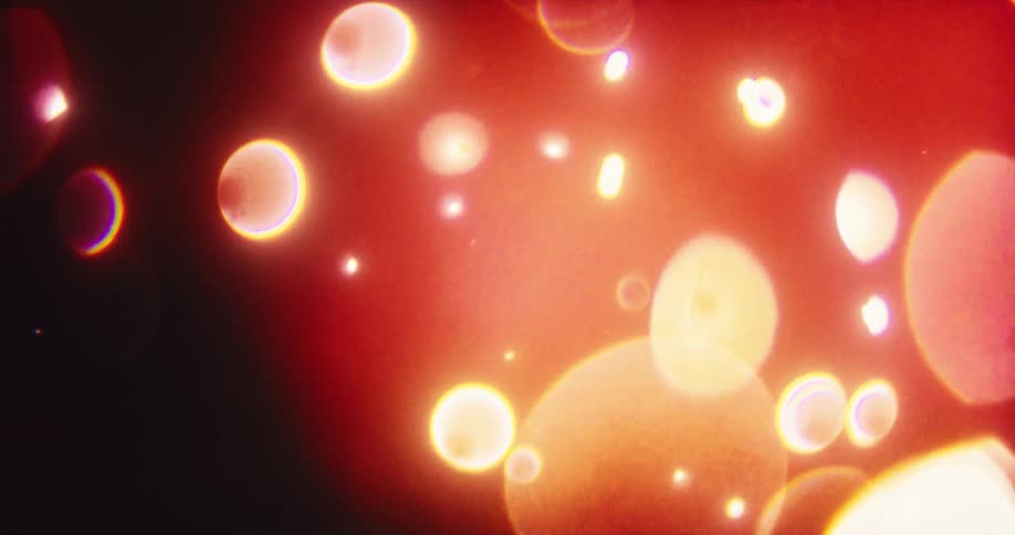 Warm, glowing bokeh orbs drift slowly in a vintage-style abstract background