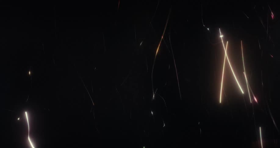 Abstract colorful glowing lines and streaks of light gracefully move and fall against a dark background