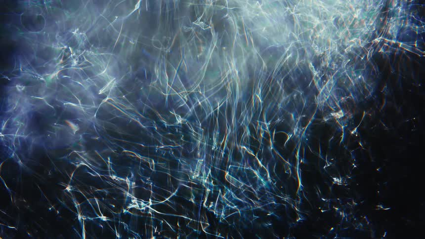 A mesmerizing web of glowing, fibrous light patterns with soft bokeh shimmers against a dark background