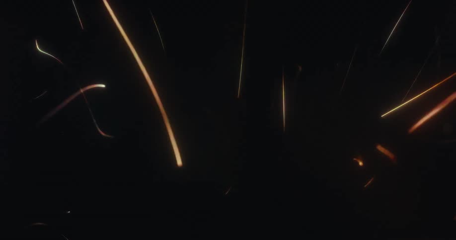 Fiery sparks and glowing embers dance and fly through the dark void