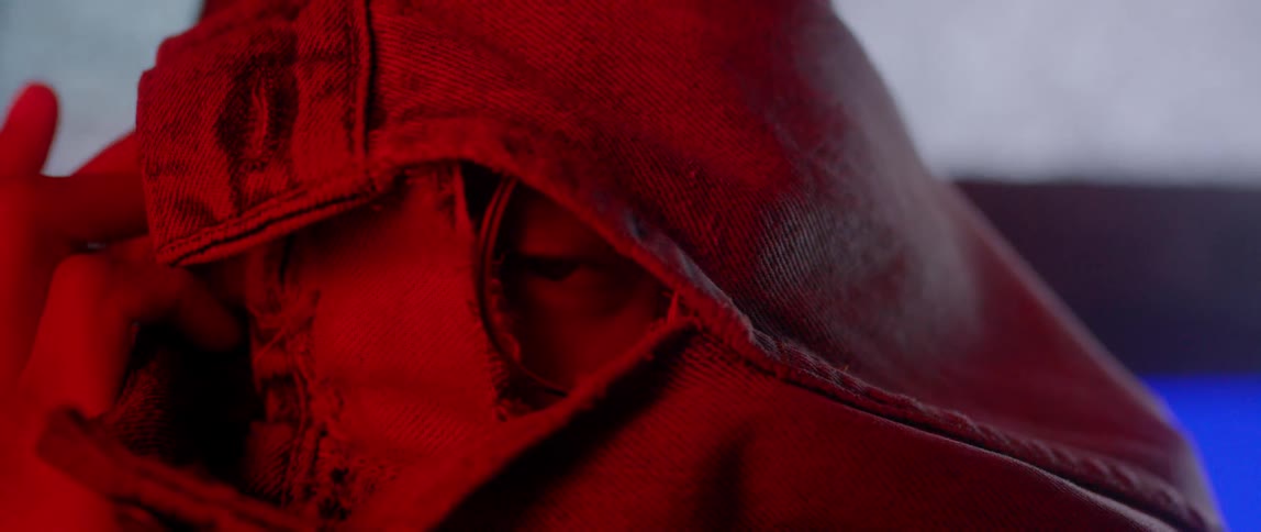 Close up of an eye peering out from a coat