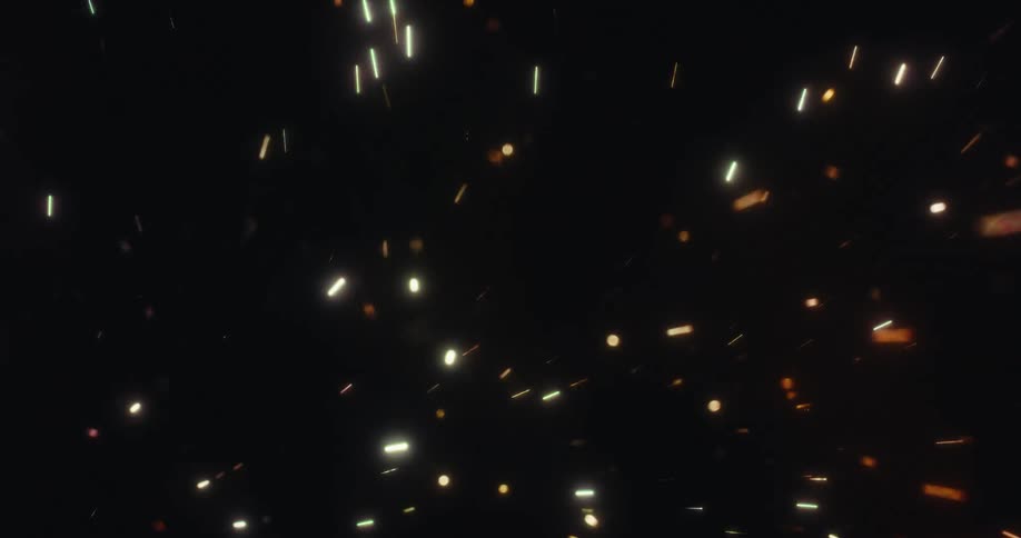 Magical glowing embers and colorful particles float and drift across an abstract black background