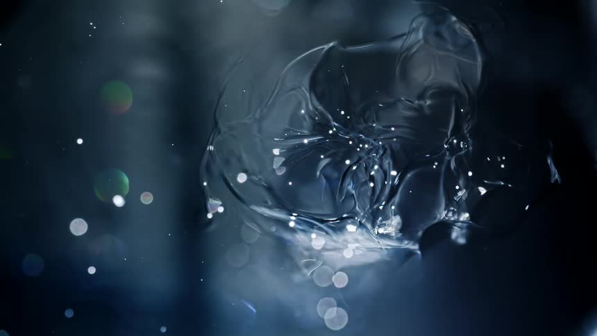 A dreamy abstract visual of a translucent blue form surrounded by floating light particles and glowing bokeh