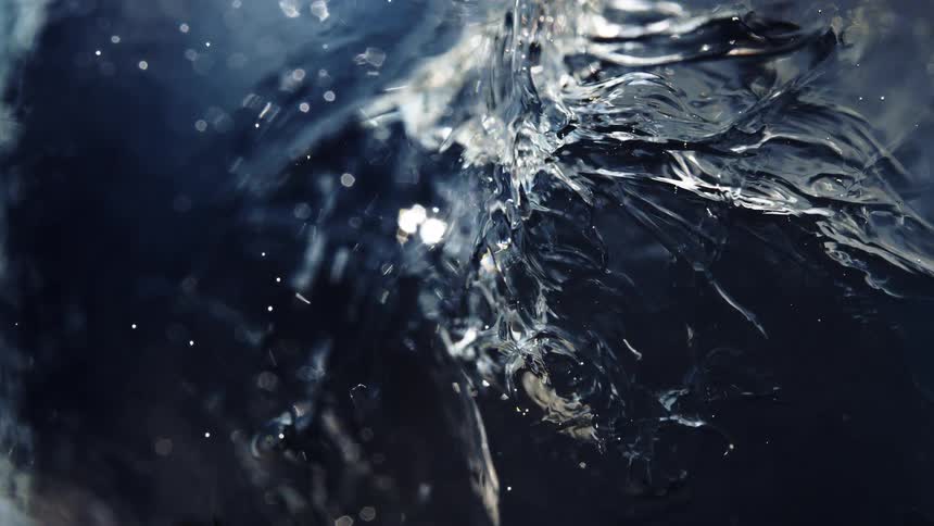 A mesmerizing extreme close-up of water as it slowly freezes, forming beautiful and intricate ice crystals