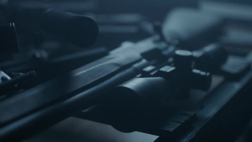 A gun sits on a table