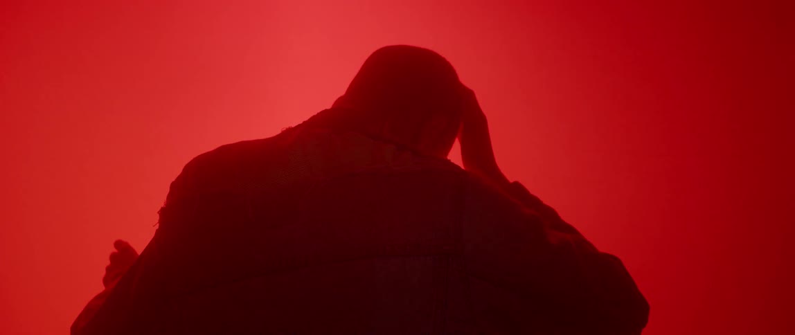 A person is leaning towards a red light