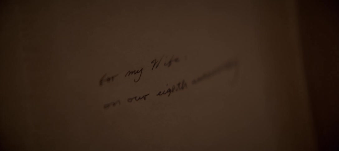 An intimate, warm close-up slowly reveals a handwritten anniversary message dedicated to a beloved wife