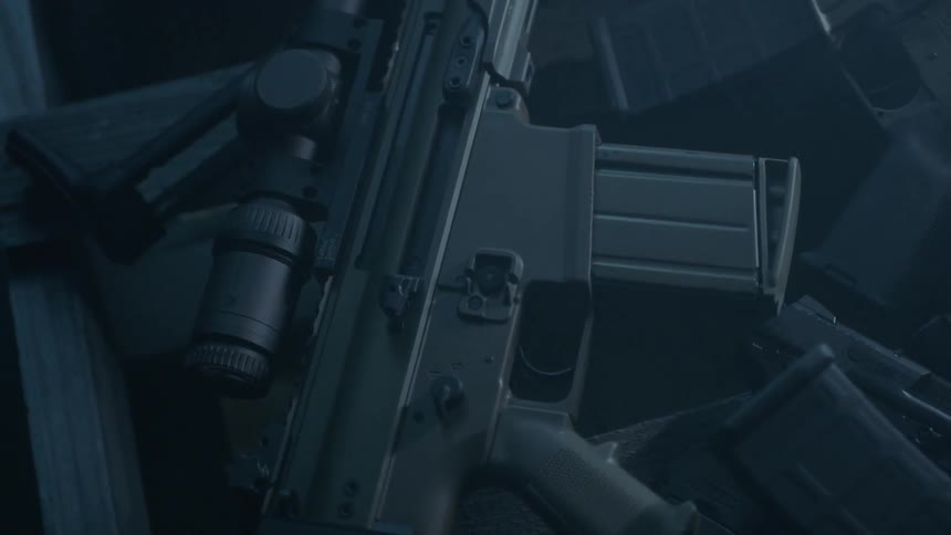A gun and ammunition clips sit on the ground