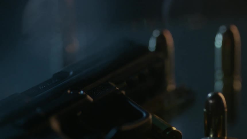 Bullets and a gun are on the ground