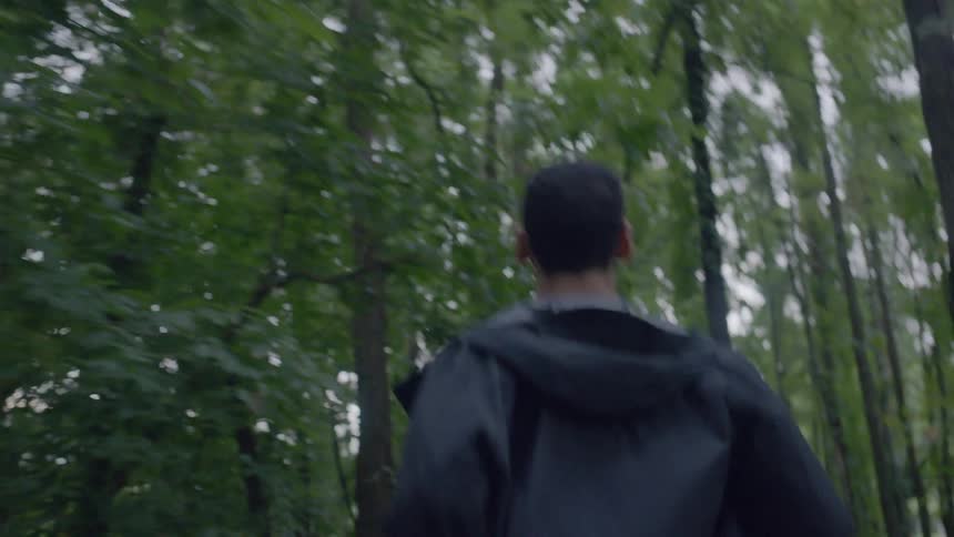 A man is running in the woods