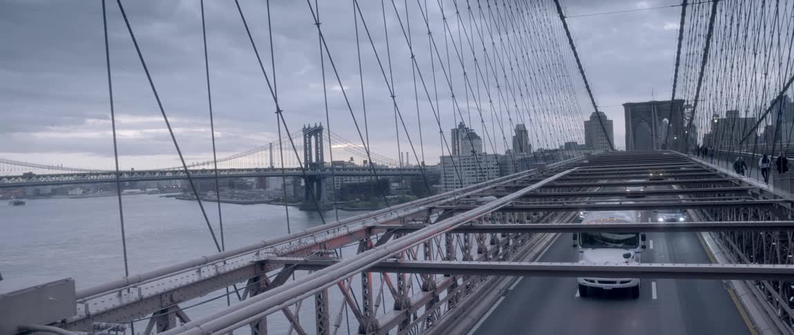 Cars travel over the bridge on a cloudy day