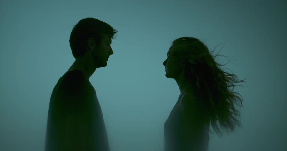 A man and woman turn towards each other