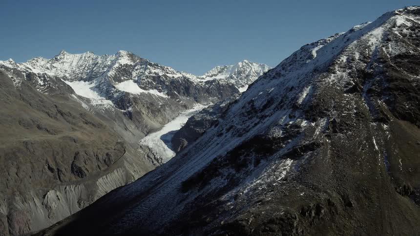 The mountains are tall and covered with snow
